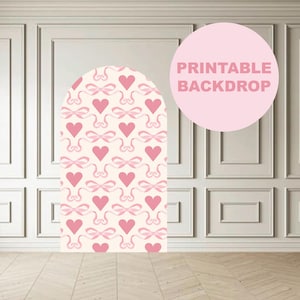 May include: Printable backdrop with a pink and white heart and bow pattern. The text "Printable Backdrop" is written in pink on a pink circle.