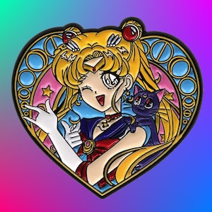 May include: A heart-shaped enamel pin featuring a cartoon anime character with blonde hair, a blue and red outfit, and a black cat. The character is holding a hand up in a peace sign. The pin has a stained glass design with blue, pink, and yellow colors.