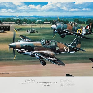 May include: A vintage illustration of two fighter planes, a P-40 Warhawk and a Curtiss P-40, in flight. The P-40 Warhawk is painted in a camouflage pattern with a shark mouth on the nose and the number 18 on the side. The Curtiss P-40 is painted in a green and brown camouflage pattern with the letters "CORD" on the side. The illustration is titled "Flying Tigers and Buffalos" by Stan Stokes.