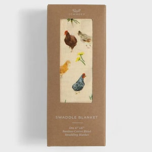 May include: A swaddle blanket in a cardboard box. The blanket features a cream background with colorful illustrations of chickens and flowers. The box reads "SWADDLE BLANKET" and "One 47"x47" Bamboo-Cotton Blend Swaddling Blanket."