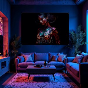 May include: A large wall art print featuring a woman with intricate body art in neon colors against a black background. The artwork is displayed in a living room setting with a sofa, coffee table, and decorative plants.