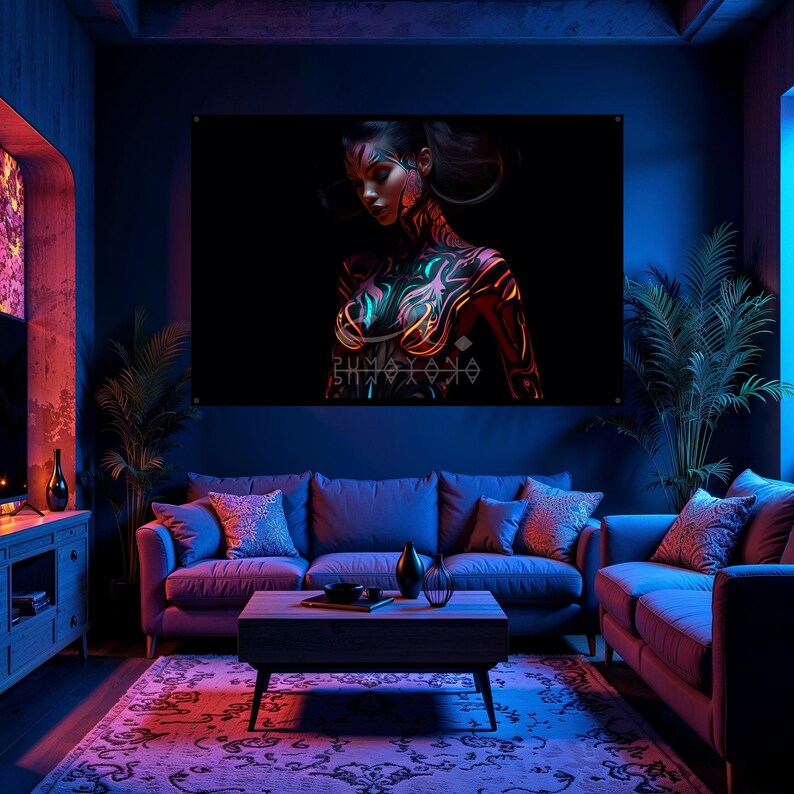 May include: A large wall art print featuring a woman with intricate body art in neon colors against a black background. The artwork is displayed in a living room setting with a sofa, coffee table, and decorative plants.