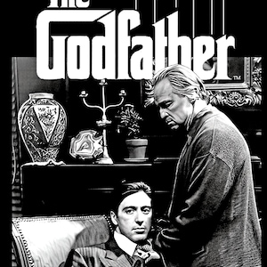 May include: Black and white image of a scene from the movie "The Godfather". A man sits in a chair with a serious expression on his face. Another man stands behind him, looking down at him. The word "Godfather" is written in large, bold letters at the top of the image.