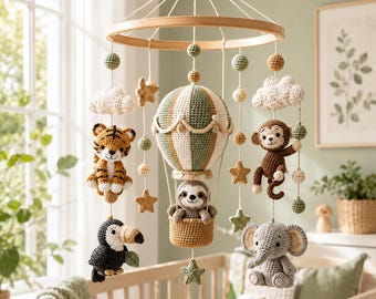 May include: A nursery mobile featuring a central crocheted hot air balloon with a sloth in the basket, surrounded by crocheted figures of a tiger, monkey, toucan, and elephant, accented with crocheted clouds, stars, and spheres on a wooden frame.