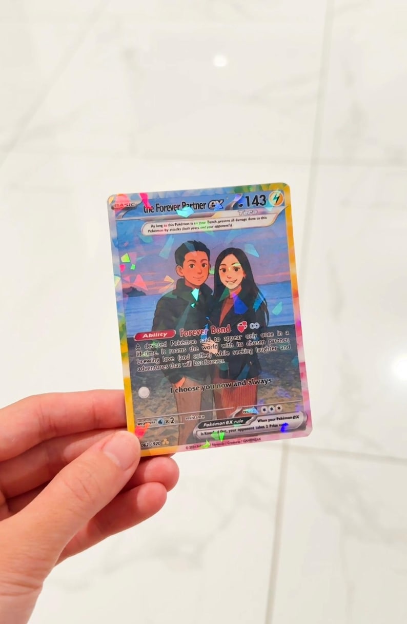 May include: A rectangular trading card featuring a holographic finish and an illustration of two people standing on a beach at sunset. The text reads The Forever Partner EX, 143 HP, Ability Forever Bond, and I choose you now and always.