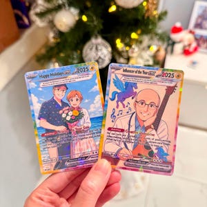 May include: Two custom trading cards featuring anime-style illustrations. The left card, Happy Holidays 2025, shows a couple with a bouquet. The right card, Influencer of the Year 2025, depicts a person with a guitar and a small blue winged creature.