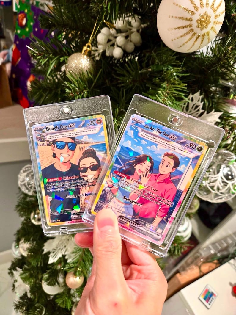 May include: Two custom trading cards in clear plastic protective cases. The left card is titled Beach Day EX and features an illustration of a couple on a beach. The right card is titled You Are The One EX and shows a couple in a romantic setting.
