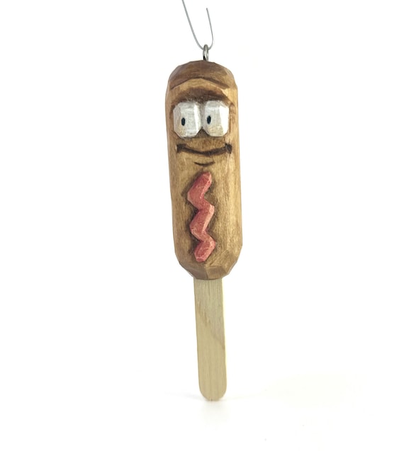 A hand-carved wooden corndog ornament is the exact kind of absurd, hyper-specific novelty that wins every white elephant exchange.