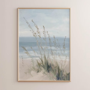 May include: A vertical framed wall art print featuring an oil painting of a coastal scene. The artwork depicts tall, slender beach grasses in shades of green and tan in the foreground, set against a soft blue ocean and a pale, cloudy sky.
