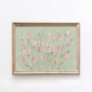 May include: A framed painting of pink flowers on thin stems set against a pale green backdrop. The artwork is presented within a rustic, light brown wooden frame, giving a vintage feel. The painting has a spring-like quality.