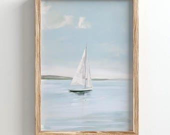 May include: A framed wall art print featuring a painting of a white sailboat on calm, light blue water under a soft, pale sky. The artwork is enclosed in a light-toned wooden frame with a visible grain, creating a clean and simple display.