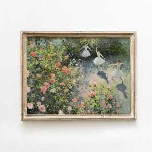 May include: A framed painting depicting three ballerinas dancing in a garden setting. The garden is filled with lush greenery and pink roses. The ballerinas are wearing white tutus and are gracefully posed.