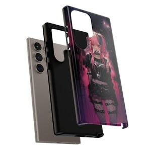 May include: A black phone case with a colorful anime character design. The character has pink hair and is wearing a black outfit with a white heart on the chest. The case has a raised camera bump and a black border.