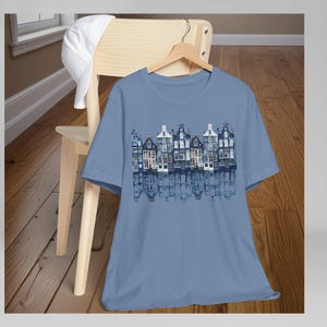 Netherlands Travel Shirt Amsterdam Canal Houses Design Dutch Heritage Gift Delft Blue Tee Holland Souvenir Apparel Unisex Jersey Cotton Comfortable Casual Wear Architecture Print European Culture Gift World Traveler Tshirt Amsterdam Design