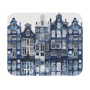 May include: A watercolor-style image of several blue buildings with white windows and architectural details. The buildings are reflected in the water below, creating a symmetrical design. The buildings are of varying heights and styles.