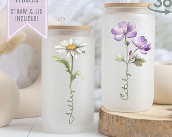 May include: Two personalized frosted glass tumblers with bamboo lids and straws. The tumblers feature floral designs and the names "Ashley" and "Catilyn".  The text "Clear or Frosted, Straw & Lid Included!" and "Personalization" are also visible.