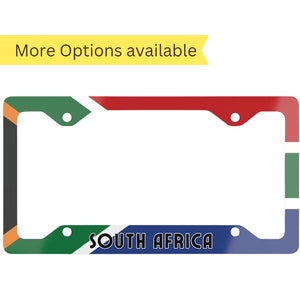 May include: Rectangular license plate frame featuring the South African flag design. The frame has a white background with the flag's colors: green, yellow, black, red, blue, and white. The text "SOUTH AFRICA" is printed in white.