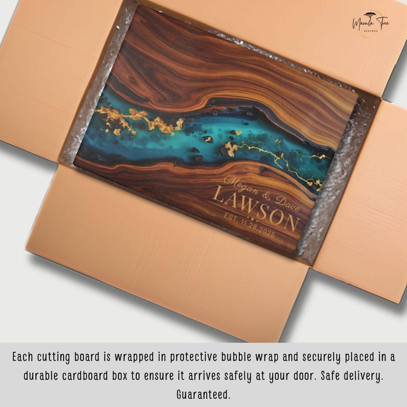 May include: A rectangular wooden cutting board with a turquoise and gold resin design, personalized with the names "Megan & Dave Lawson" and the date "EST. 11.20.2025". The board is inside a cardboard box.