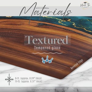 May include: A close-up of a wooden cutting board with a textured surface and a beveled edge. The board has a dark brown wood grain pattern with teal and gold accents. The text "Textured Tempered glass" is visible. The board is approximately 0.24 to 0.31 inches thick.
