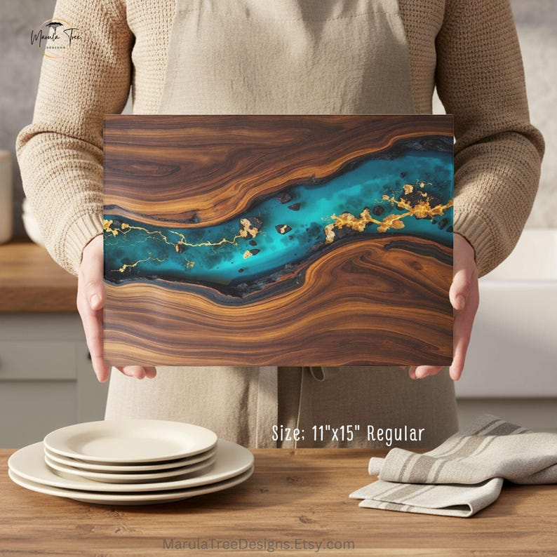 May include: A rectangular wooden serving board with a turquoise river design and gold accents. The board measures 11" x 15" and features a rich, natural wood grain. The design incorporates a vibrant turquoise resin river with gold leaf details.