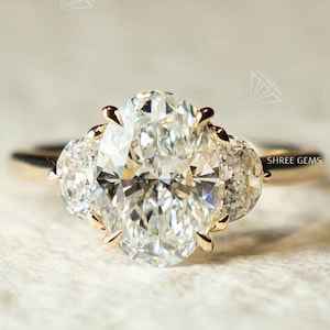 Vintage-inspired Three Stone Oval Cut Moissanite Diamond Flanked by Tiered Half-Moon Side Stones in 14K Yellow Gold Ring