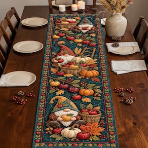 May include: A rectangular table runner featuring a dark teal background with a repeating autumn harvest pattern. The design includes gnomes wearing patterned hats, woven baskets filled with red apples, orange pumpkins, and colorful fall leaves.