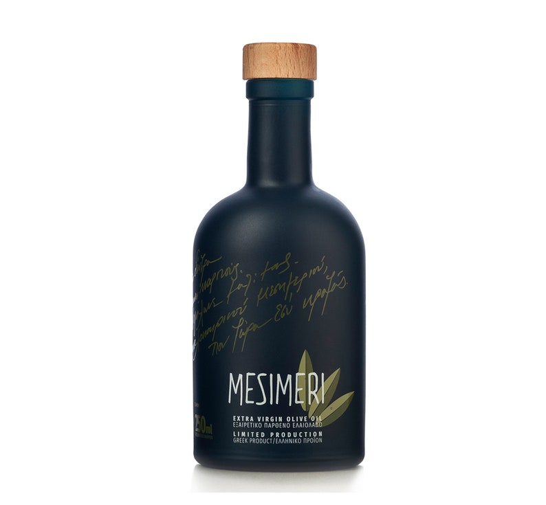 May include: A black glass bottle of Mesimeri Extra Virgin Olive Oil with a wooden cap. The bottle has a handwritten label in Greek and English. The label says "Mesimeri Extra Virgin Olive Oil, &Epsilon;&xi;&alpha;&iota;&rho;&epsilon;&tau;&iota;&kappa;ό &Pi;&alpha;&rho;&theta;έ&nu;&omicron; &Epsilon;&lambda;&alpha;&iota;ό&lambda;&alpha;&delta;&omicron;, Limited Production, Greek Product/&Epsilon;&lambda;&lambda;&eta;&nu;&iota;&kappa;ό &Pi;&rho;&omicron;ϊό&nu;".