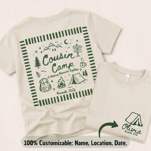 May include: A cream-coloured t-shirt featuring a dark green graphic on the back with the text "Cousin Camp Making Memories Together Yosemite 2026" surrounded by camping icons. A smaller matching graphic with "Olivia Yosemite 2026" is on the front.