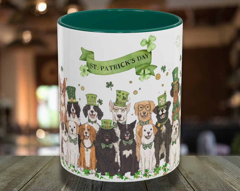 May include: White ceramic mug with a green rim, featuring a festive St. Patrick's Day design. The mug depicts a group of dogs wearing shamrock hats and holding green shamrocks. The text "St. Patrick's Day" is displayed on a green banner.