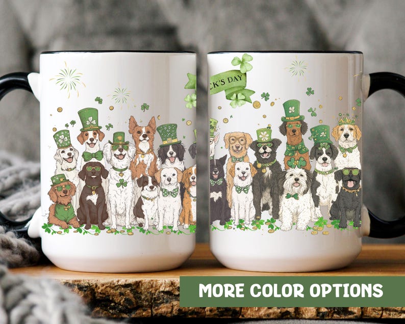 May include: Two white ceramic mugs with black handles. The mugs feature a design of dogs wearing green hats and shamrocks. The text "St. Patrick's Day" is on the mug on the right.