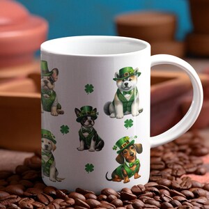 May include: White ceramic mug with a green, white, and brown design featuring five dogs wearing green hats and green vests. The dogs are a French Bulldog, a Boston Terrier, a Labrador Retriever, an Akita, and a Dachshund. The mug has a white handle.