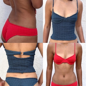 May include: A set of crochet clothing featuring a dark blue camisole with thin straps and a metal ring detail on the back, paired with matching dark blue bottoms. Also included is a bright red crochet bikini top and matching red bikini bottoms.