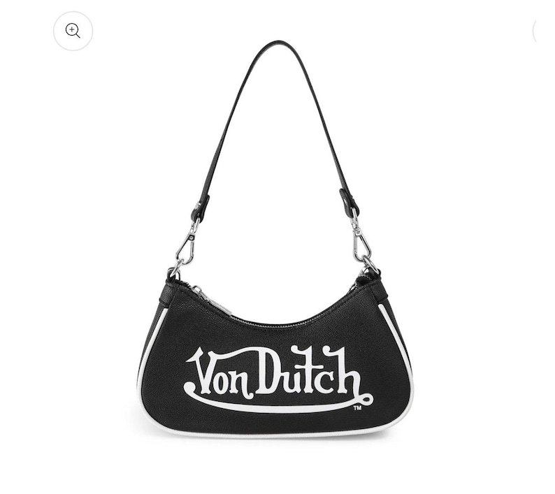 Op de afbeelding: Zwarte schoudertas met een witte rand en een enkele band. De tas heeft het witte "Von Dutch"-logo op de voorkant. De tas heeft zilverkleurige hardware.