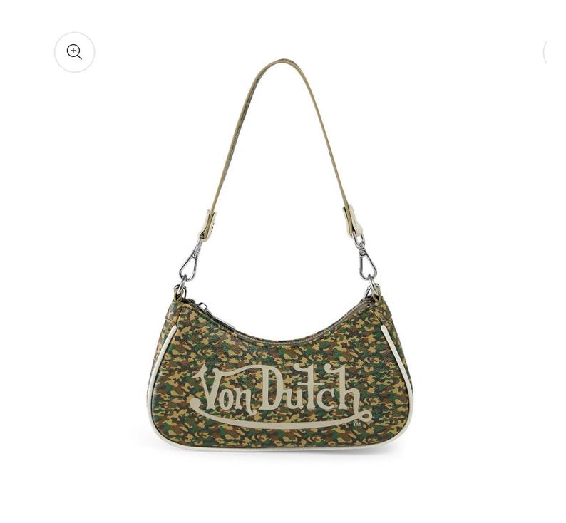 May include: A Von Dutch shoulder bag with a camouflage pattern in shades of green, brown, and tan. The bag features a curved shape, a single shoulder strap, and the Von Dutch logo in white script across the front.