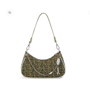May include: A green and brown camouflage print shoulder bag with a silver chain and a small wrench charm. The bag has a white trim and a thin olive green strap.