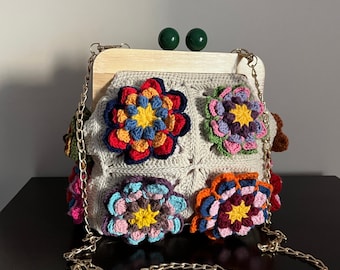 The magnificent clutch handcrafted with colorful Lotus flower motifs, Granny Square, and stylish Wooden Kiss Lock Bag