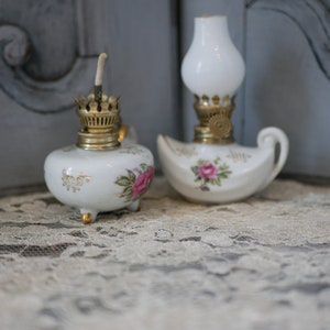 A pair of Limoges Style White Floral Porcelain Miniature Oil Lamps