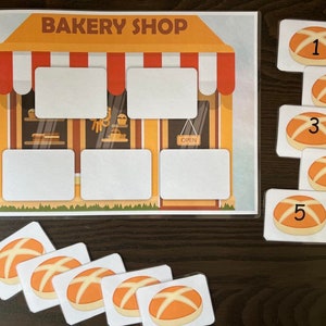 May include: A printable educational game for kids featuring a bakery shop with five different types of bread. The game includes five cards with numbers 1 through 5 and five cards with images of bread.