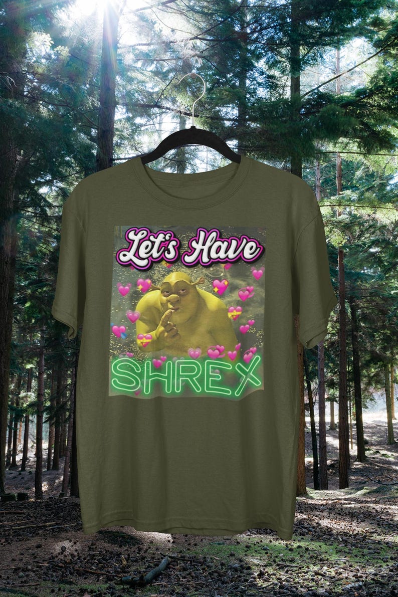May include: A green t-shirt with a graphic of Shrek with the text "Let's Have Shrex" in a neon green font.