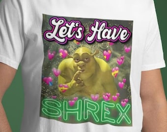 May include: White t-shirt featuring a green ogre character with the text "Let's Have Shrek" in pink and green.