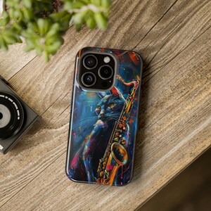 May include: A black phone case with a colorful abstract design featuring a black cat playing a gold saxophone.