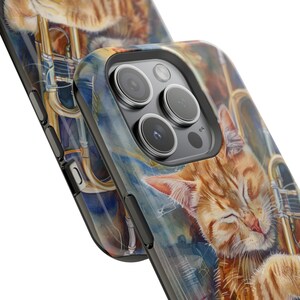May include: A black phone case with a watercolor design of a cat sleeping on a trumpet. The case has a cutout for the phone's camera lenses.