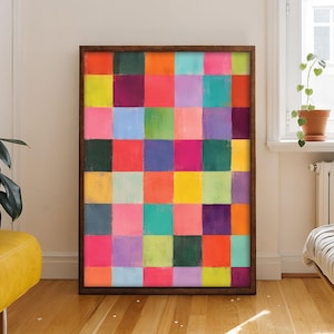 May include: A rectangular wall art piece featuring a grid of multicolored squares in shades of bright pink, orange, yellow, green, blue, purple, and dark gray. The artwork is enclosed in a dark brown wooden frame, displaying a vibrant, painted texture.
