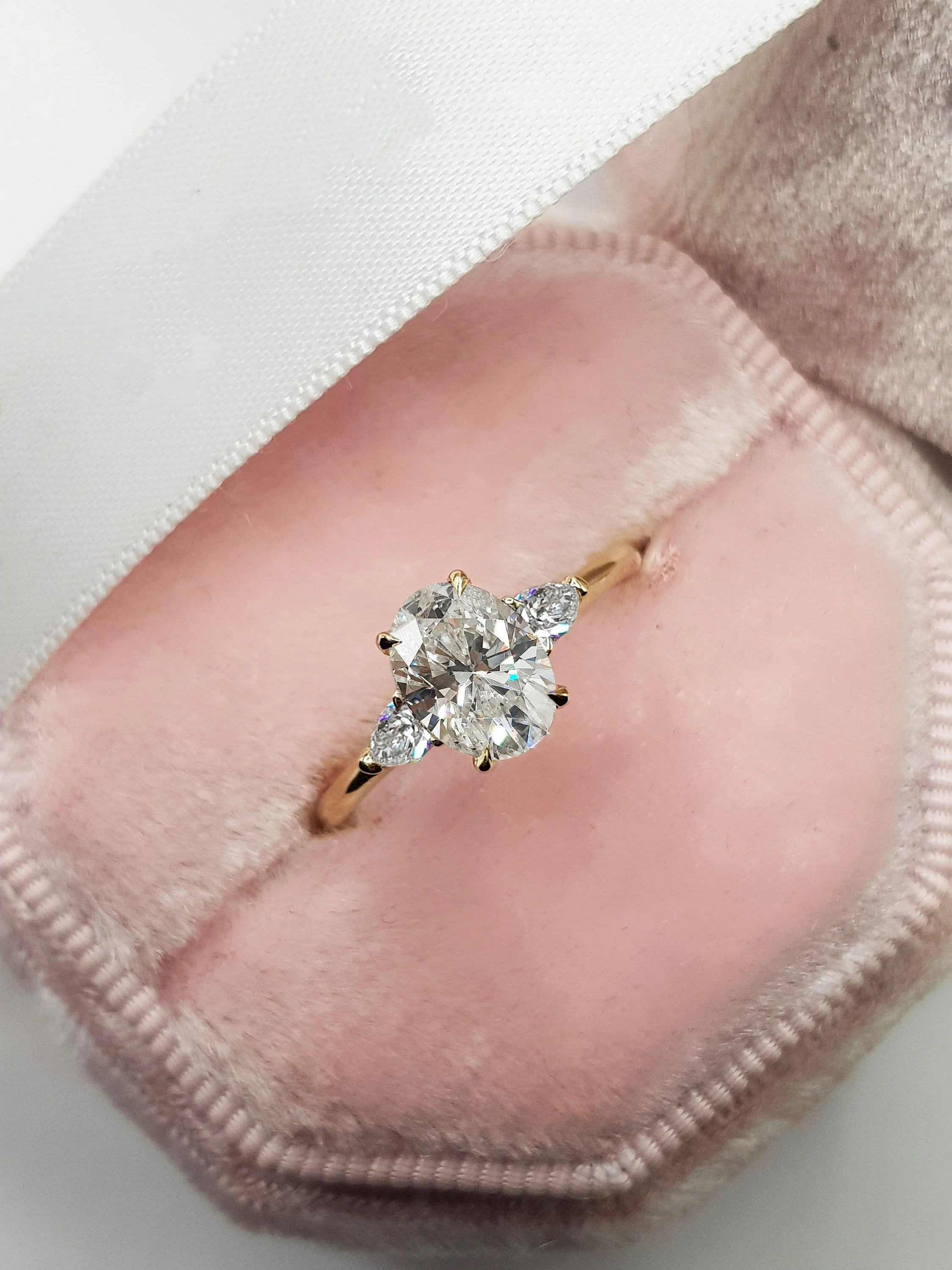 Oval diamond ring shop with pear side stones