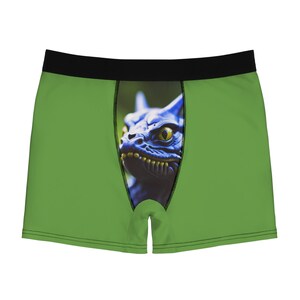 May include: Green boxer shorts with a blue monster graphic print.