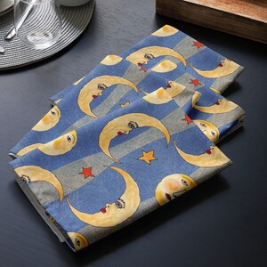 Cloth napkin set in purple with yellow moons and stars design