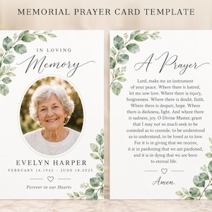 May include: A memorial prayer card template featuring two sides with green eucalyptus leaf accents. The front displays a circular photo of an older person, the text In Loving Memory, Evelyn Harper, dates, and a heart icon. The back includes A Prayer text.