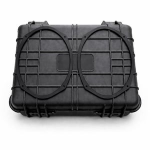 May include: A black, rectangular, hard-shell case with a textured surface. Two black, circular speaker rings are placed on top. The case has a handle and latches for secure closure. Ideal for protecting audio equipment.