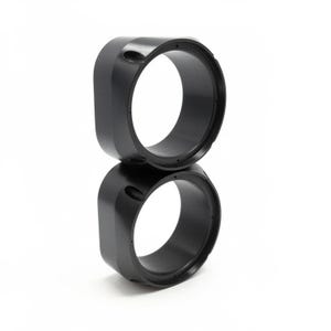 May include: A white ceramic mug with a black handle and the text "But First, Coffee" in a black, bold font. The mug is sitting on a wooden surface. The mug is approximately 4 inches tall.