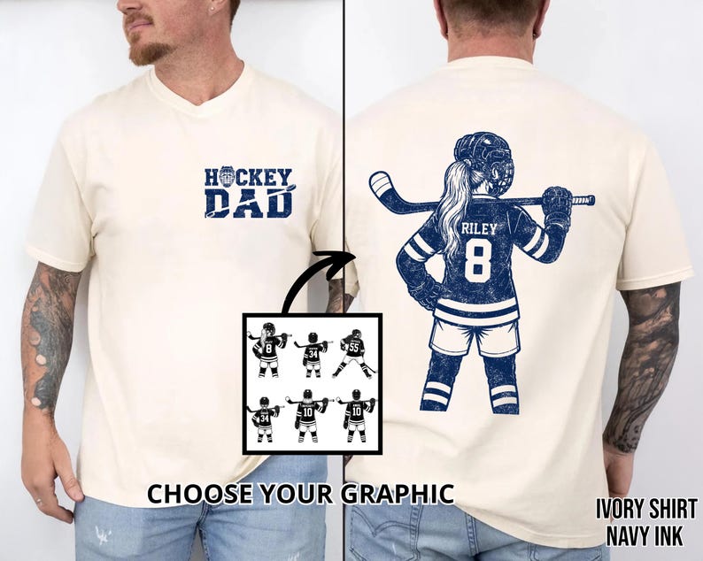 May include: Ivory-colored t-shirt with navy ink graphics. The front features "HOCKEY DAD" text. The back displays a hockey player with the name "RILEY" and the number "8". A graphic selection is shown below. The shirt is a unisex design.